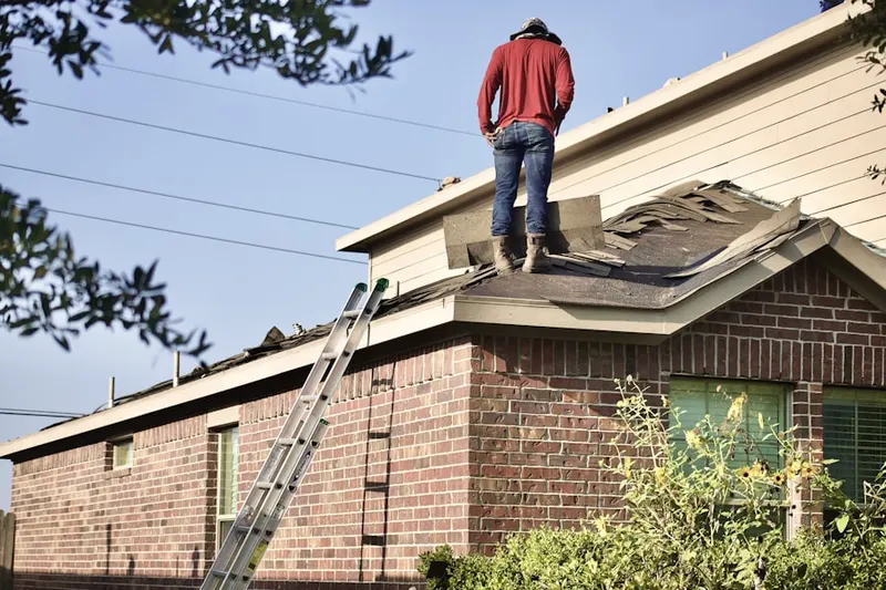 Professional roofer working on a residential roof in Lake Belvedere Estates